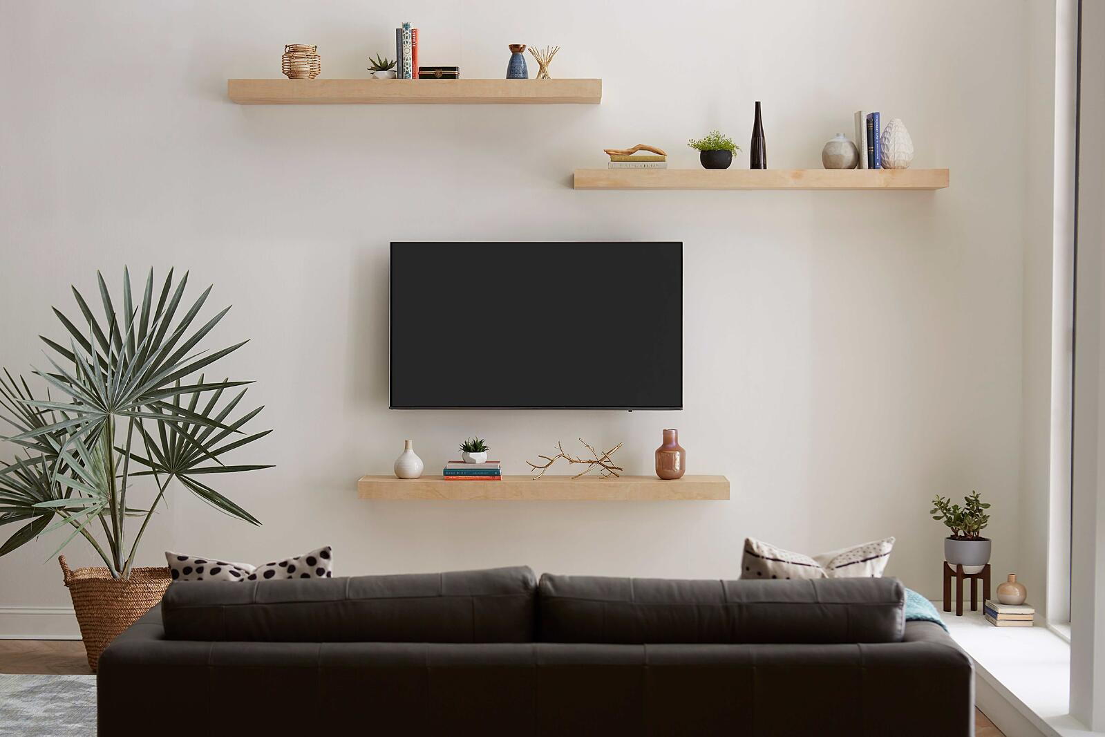 TV and Floating Shelves Mounted on Wall in Living Room